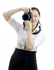 Woman taking a picture to get free images to use in your WordPress blog